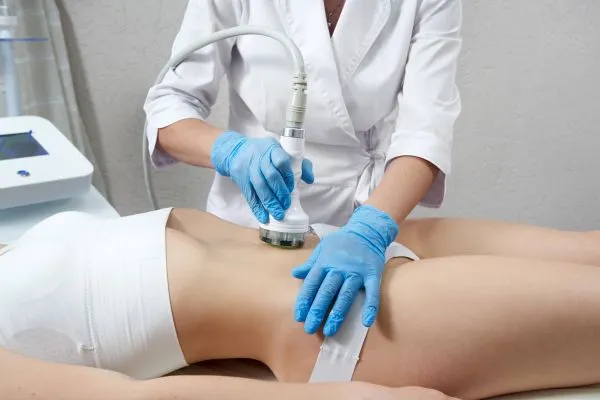 Lost the Weight but Not the Loose Skin? 2 woman having HIFU treatment on her stomach to combat loose skin Nottinghamshire following weight loss